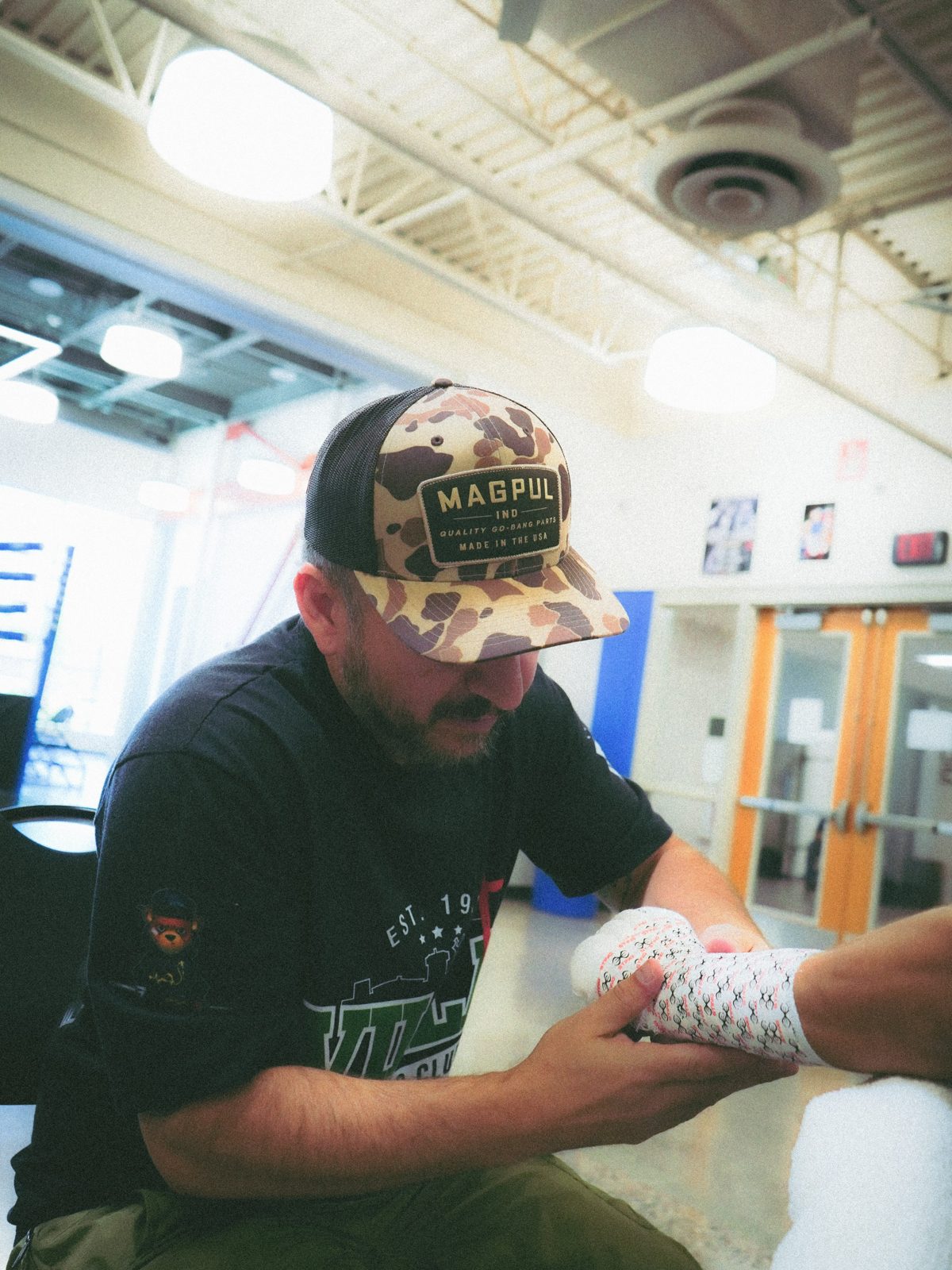 Coach Paco wrapping a fighter’s hands in the gym. Public Instagram photo by @callfrank47.