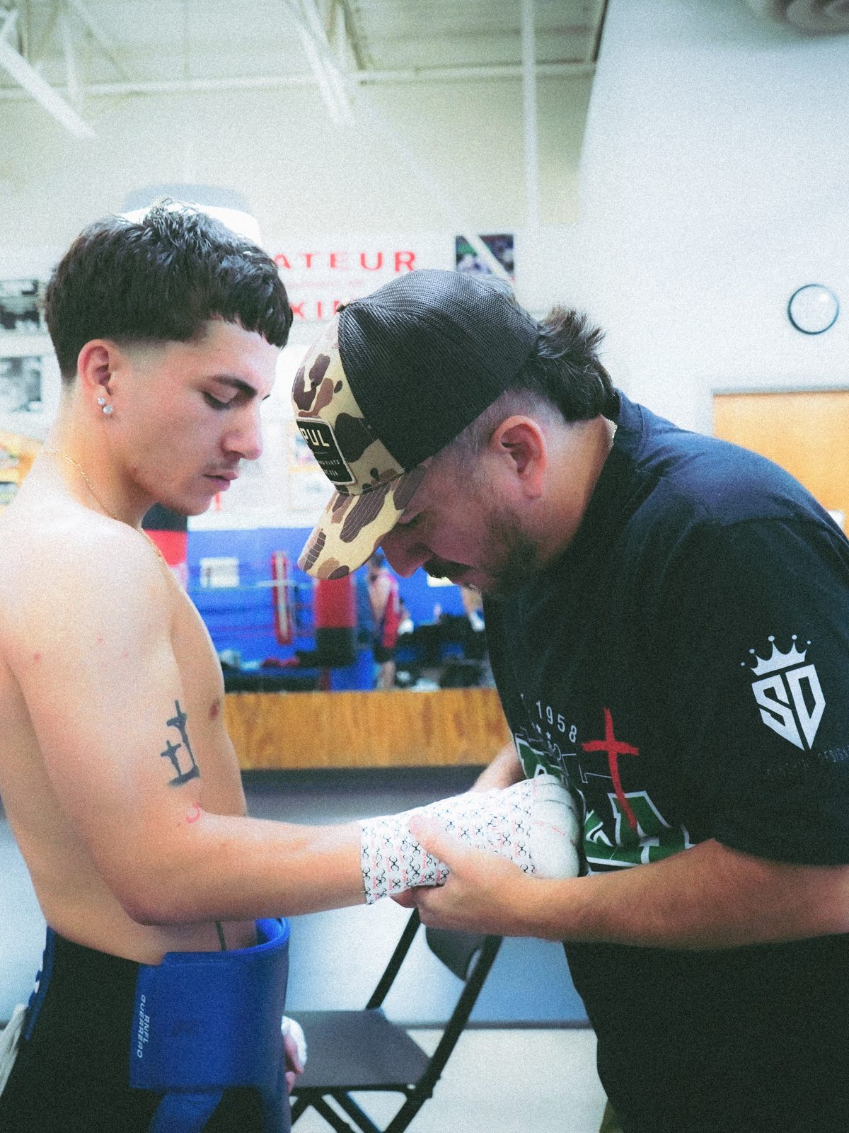 Coach Paco wrapping a fighter before training. Public Instagram photo by @callfrank47 — not a published roster listing.